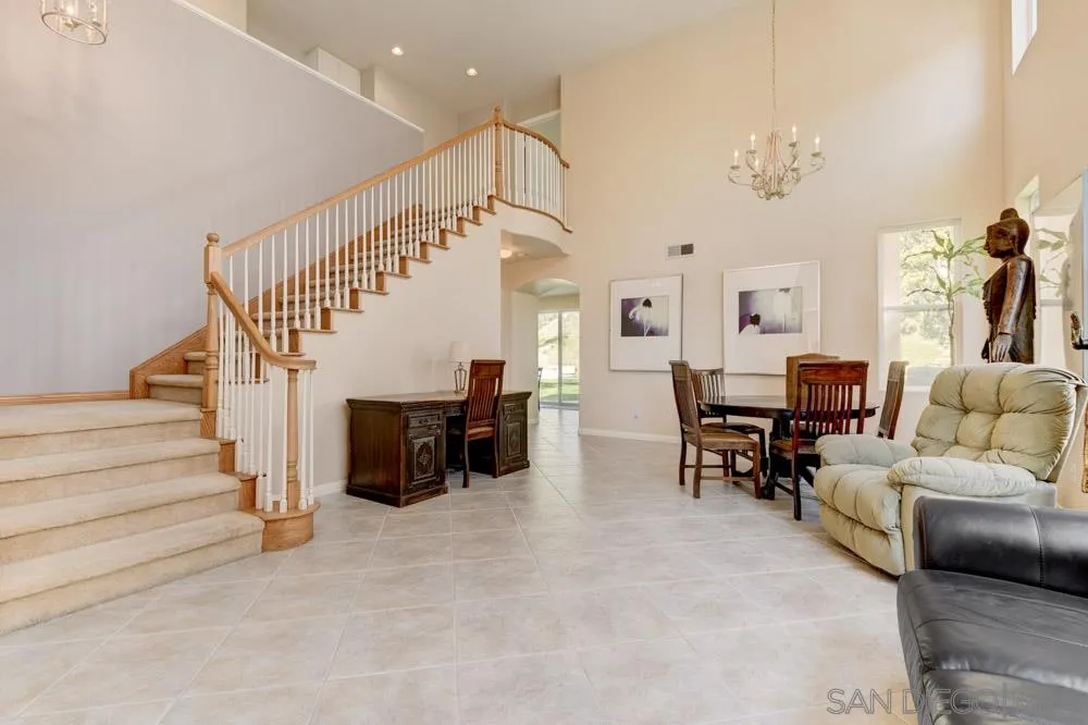 3224 Rancho Arroba Carlsbad, CA 92009 - Photo 5 of 35 a living room with furniture and a chandelier