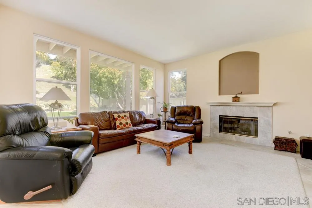 3224 Rancho Arroba Carlsbad, CA 92009 - Photo 10 of 35 a living room with furniture and a fireplace