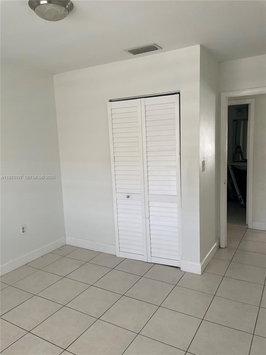 5216 West 24th Way, Unit 17D Hialeah, FL 33016 - Photo 11 of 14 an empty room with a bench