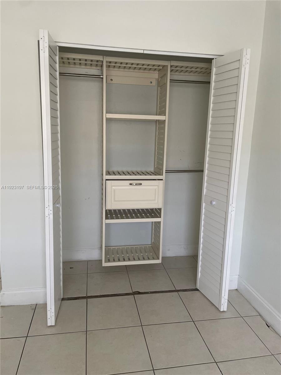 5216 West 24th Way, Unit 17D Hialeah, FL 33016 - Photo 8 of 14 a view of an empty room with cabinet and door