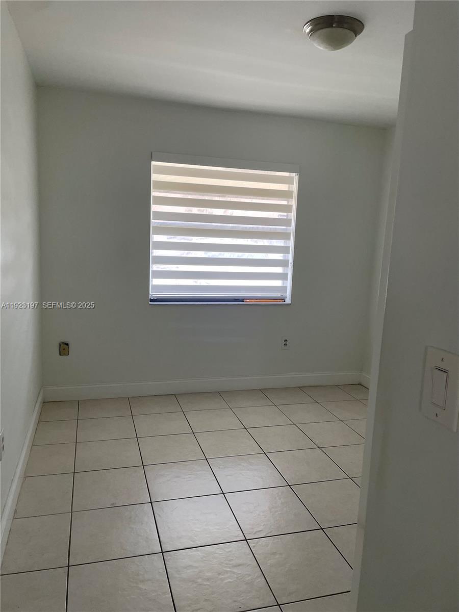 5216 West 24th Way, Unit 17D Hialeah, FL 33016 - Photo 9 of 14 a view of an empty room with a window