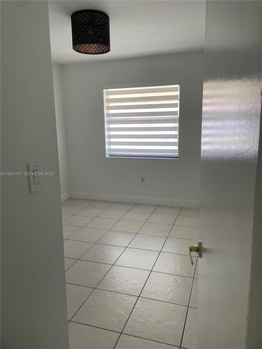 5216 West 24th Way, Unit 17D Hialeah, FL 33016 - Photo 10 of 14 a view of a air conditioner and a window