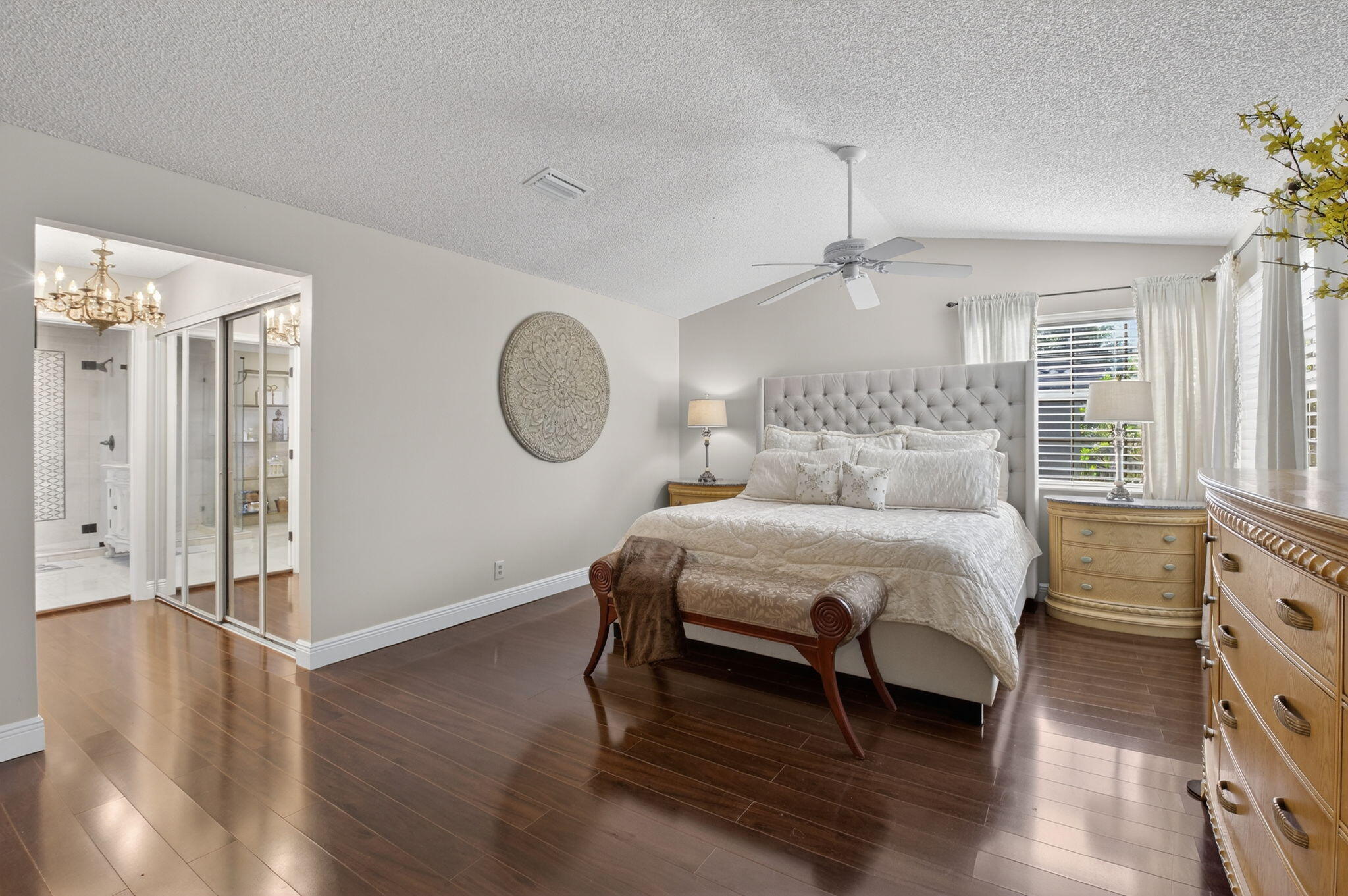 10570 Bexley Boulevard Boca Raton, FL 33428 - Photo 13 of 37 a bedroom with a bed a mirror and a window