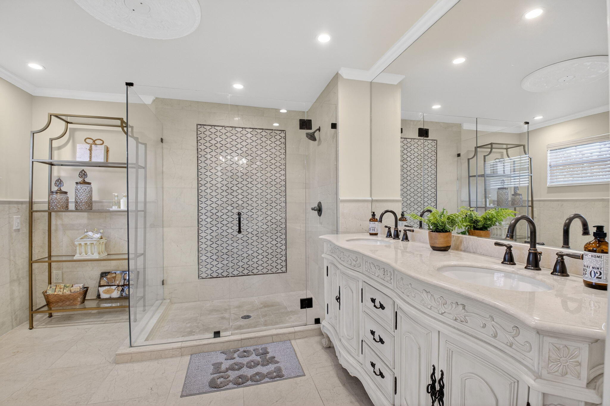 10570 Bexley Boulevard Boca Raton, FL 33428 - Photo 16 of 37 a bathroom with double vanity sink a shower and a mirror