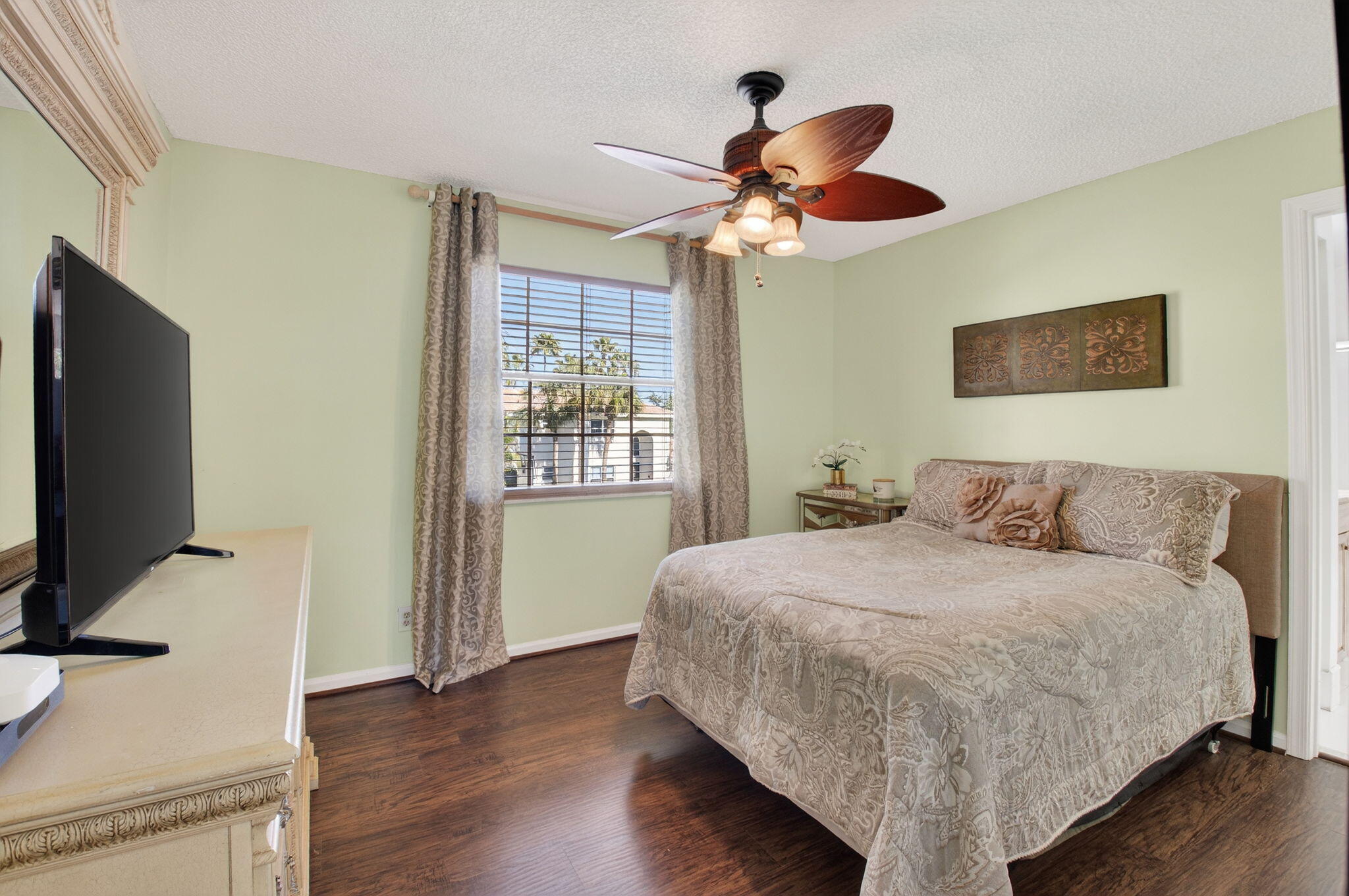 10570 Bexley Boulevard Boca Raton, FL 33428 - Photo 17 of 37 a bedroom with a bed and a flat screen tv
