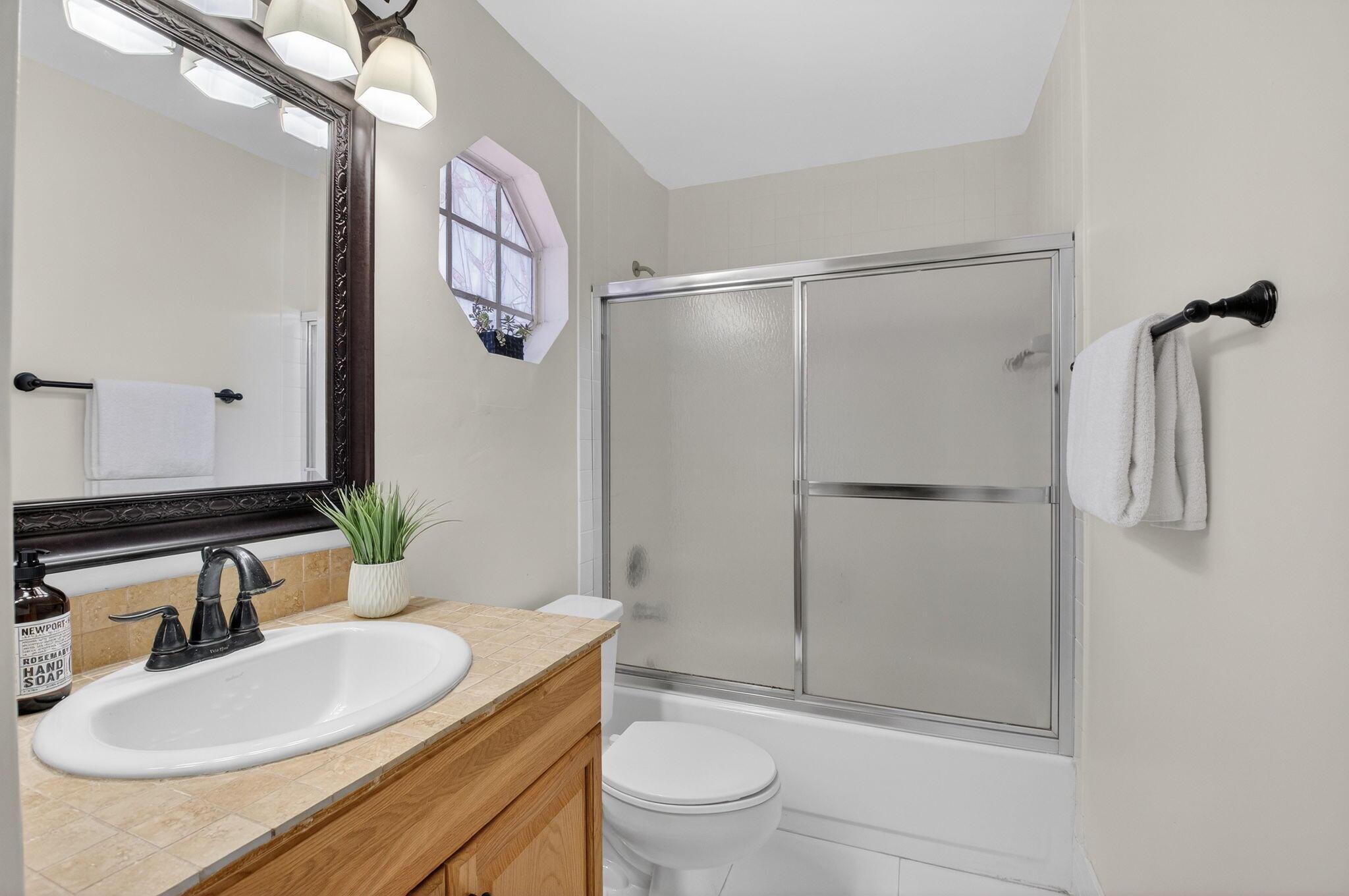 10570 Bexley Boulevard Boca Raton, FL 33428 - Photo 18 of 37 a bathroom with a sink a toilet a mirror and shower