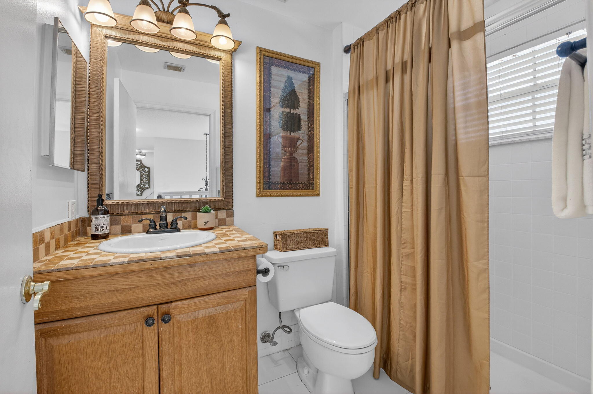 10570 Bexley Boulevard Boca Raton, FL 33428 - Photo 20 of 37 a bathroom with a granite countertop sink toilet and mirror