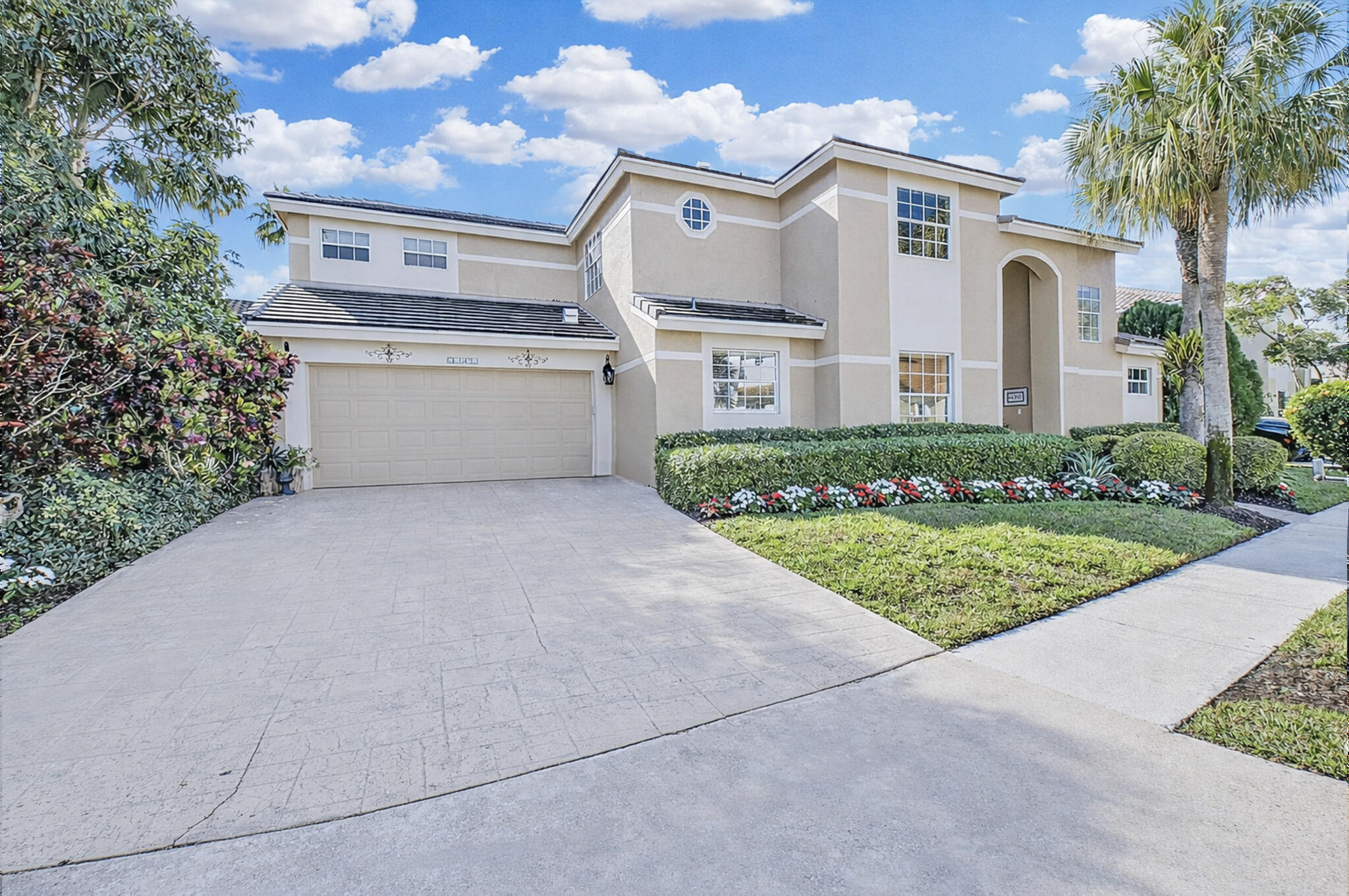 10570 Bexley Boulevard Boca Raton, FL 33428 - Photo 2 of 37 a front view of a house with garden