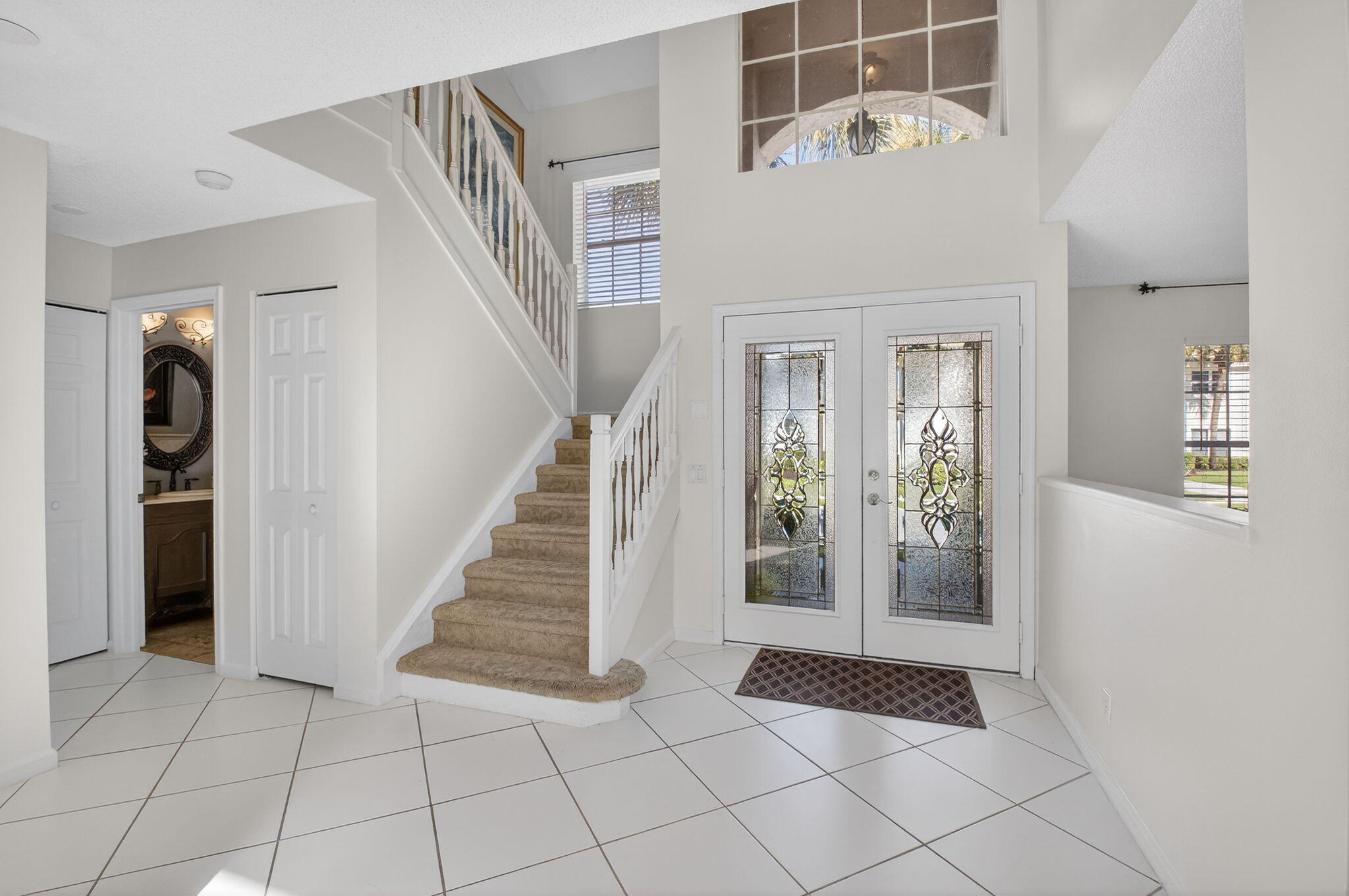 10570 Bexley Boulevard Boca Raton, FL 33428 - Photo 3 of 37 a view of entryway with stairs and wooden floor