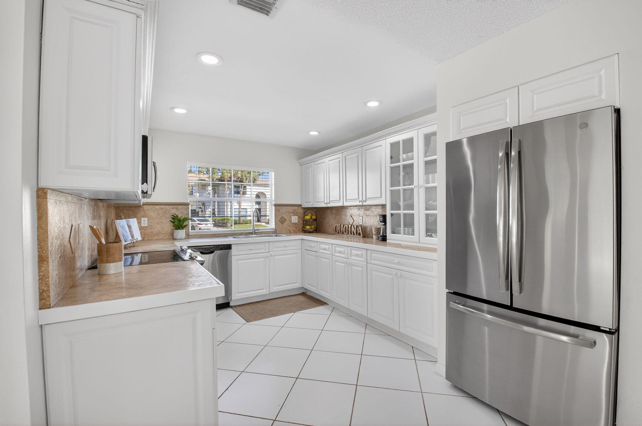 10570 Bexley Boulevard Boca Raton, FL 33428 - Photo 8 of 37 a kitchen with a refrigerator a sink and cabinets