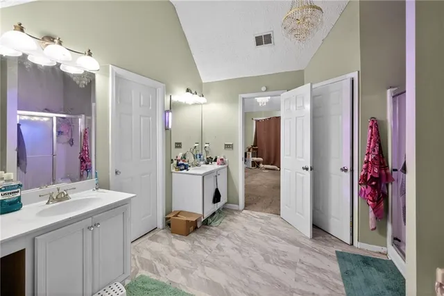 a bedroom with a bed and a chandelier