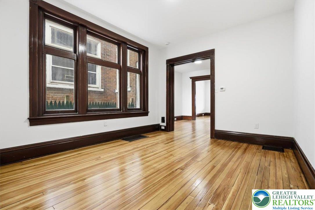 524 Fiot Street Bethlehem, PA 18015 - Photo 11 of 42 a view of an empty room with wooden floor and a window