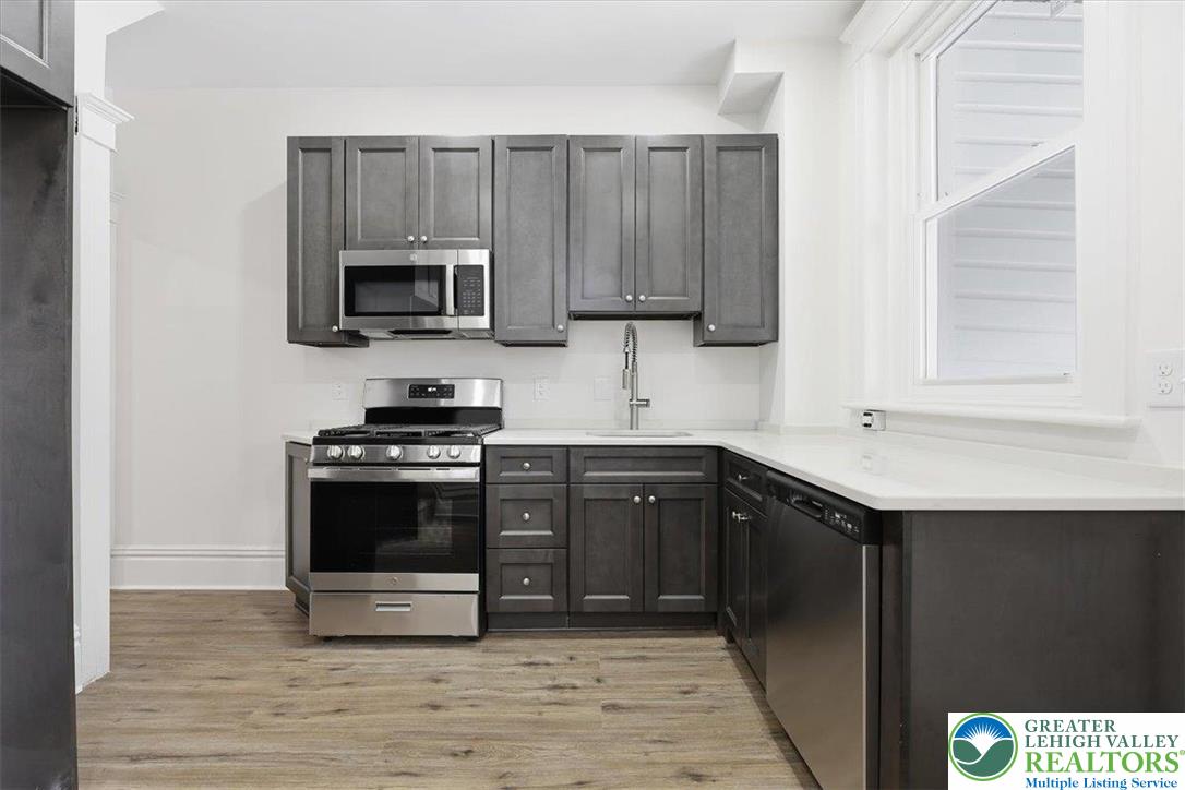 524 Fiot Street Bethlehem, PA 18015 - Photo 12 of 42 a kitchen with stainless steel appliances granite countertop a stove a microwave and a sink