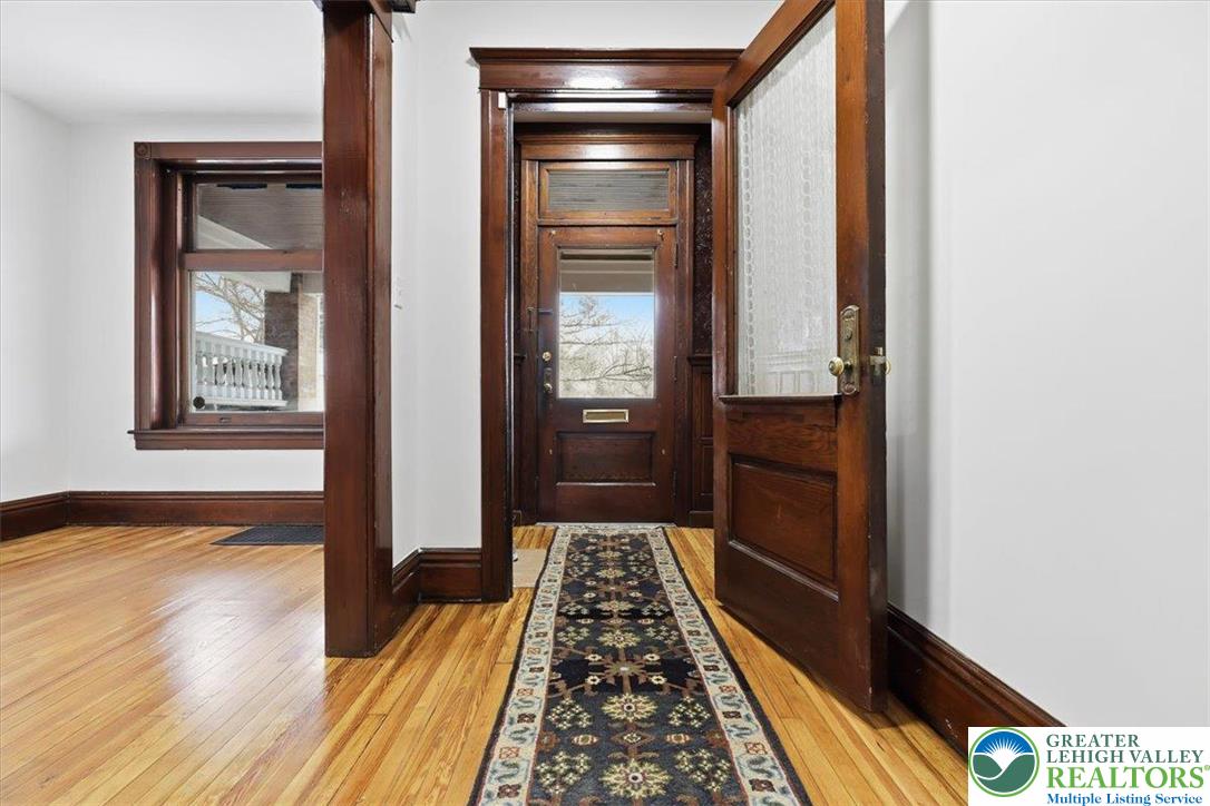 524 Fiot Street Bethlehem, PA 18015 - Photo 3 of 42 a hallway with wooden floor table and chair