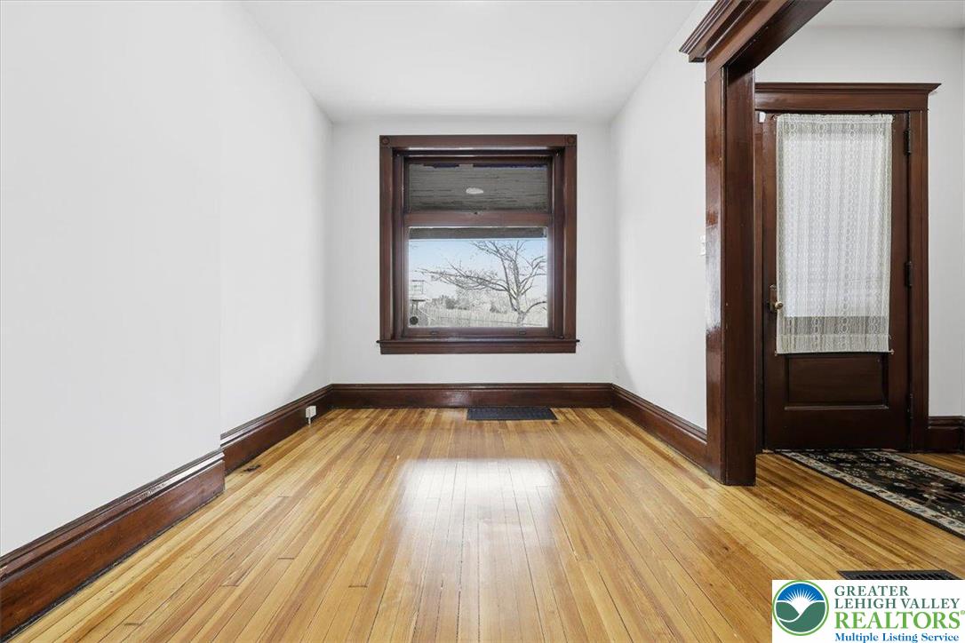 524 Fiot Street Bethlehem, PA 18015 - Photo 5 of 42 a view of an empty room with wooden floor and a window