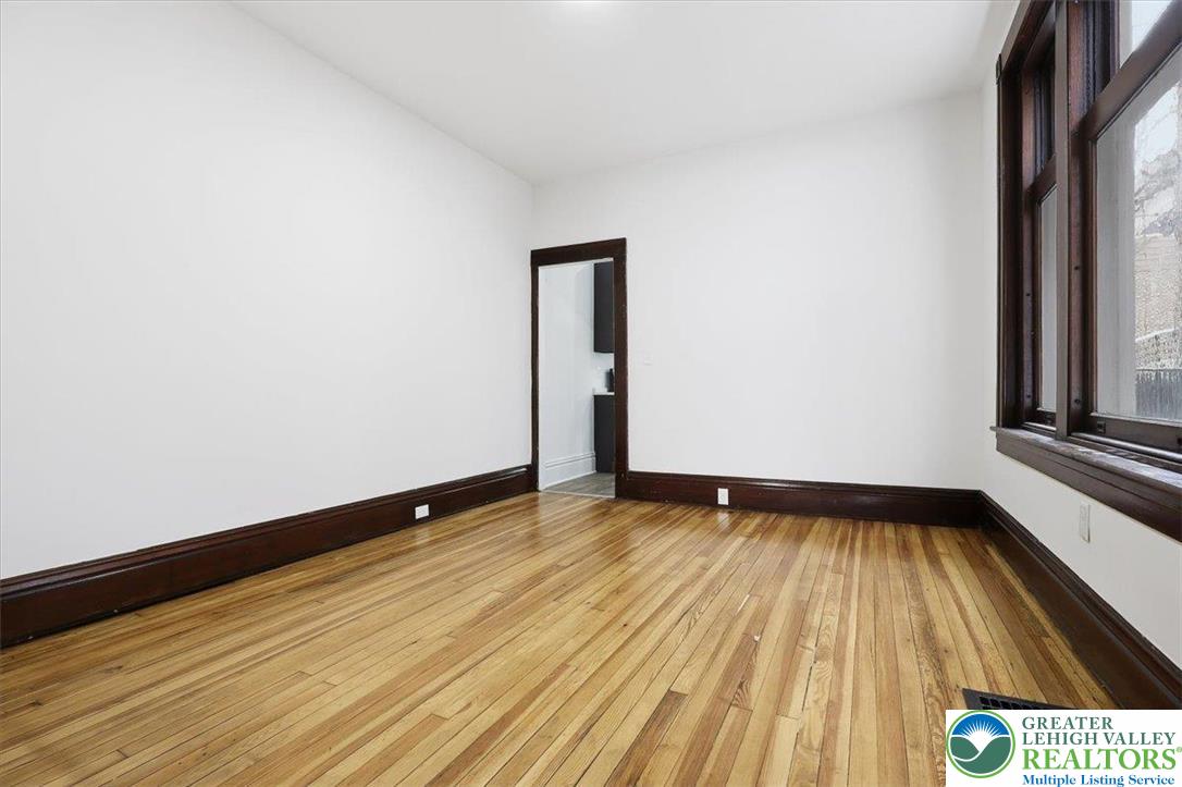 524 Fiot Street Bethlehem, PA 18015 - Photo 8 of 42 a view of an empty room with wooden floor and a window