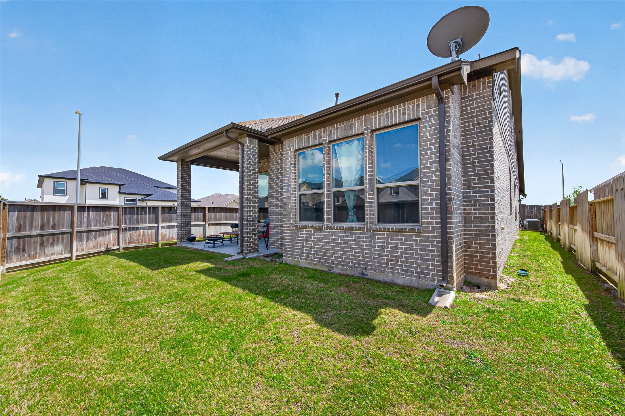 20802 Mirror Point Drive Cypress, TX 77433 - Photo 36 of 37 This brick home has a fenced backyard, featuring a covered patio area suitable for outdoor seating. The yard is spacious, and ideal gatherings or relaxing.