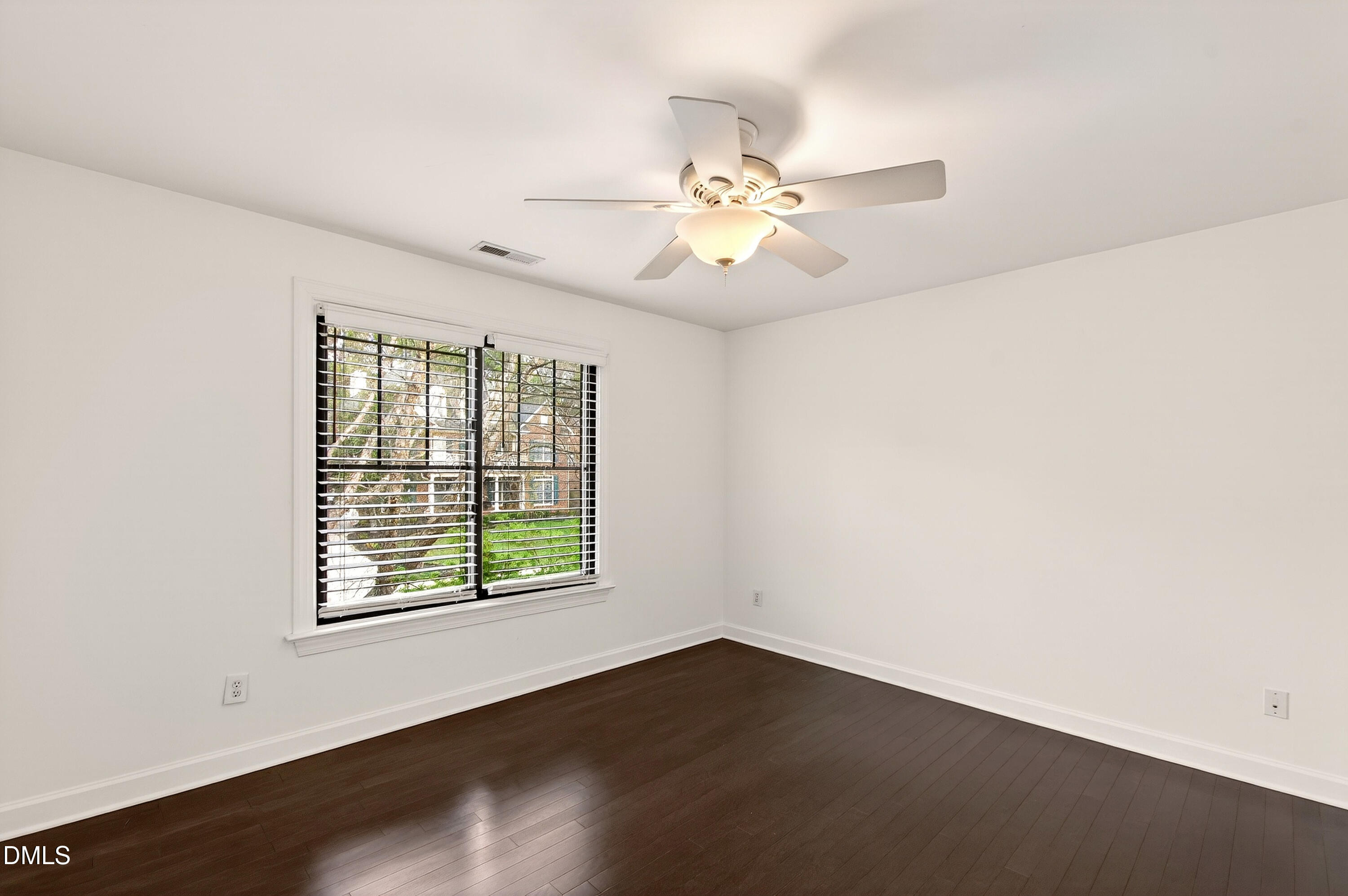 12408 Cilcain Court Raleigh, NC 27614 - Photo 37 of 80 an empty room with wooden floor fan and windows
