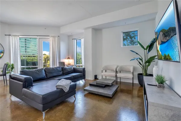 a living room with furniture and a mirror