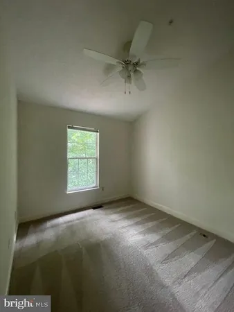 an empty room with a fireplace and a window