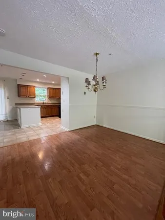 a view of kitchen with stainless steel appliances granite countertop a refrigerator and a sink