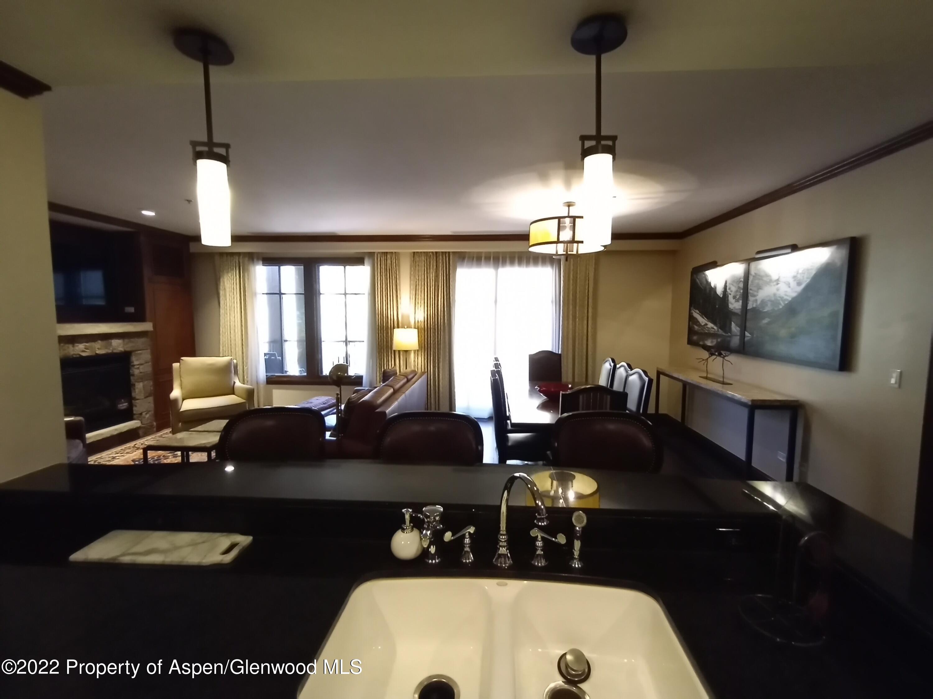 75 Prospector Road, Unit 8203 SUMMER INTEREST 9 Aspen, CO 81611 - Photo 7 of 28 a kitchen with a sink a stove and chairs