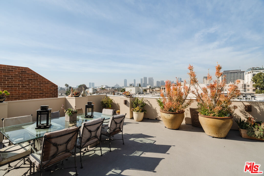 a view of a terrace with furniture and potted plants