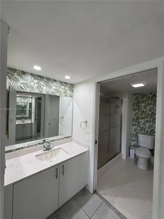 a bathroom with a sink and a large mirror