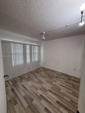 a view of a room with a wooden floor