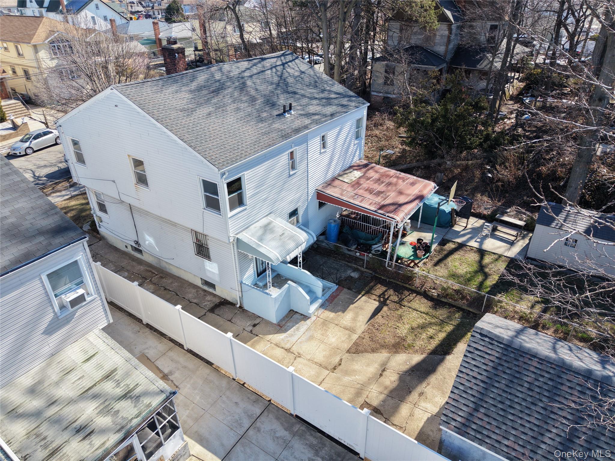 219-42 141st Road Queens, NY 11413 - Photo 12 of 23 a roof deck with table and chairs with wooden floor