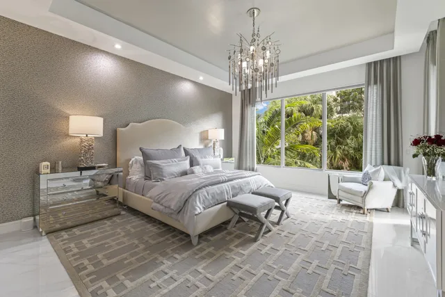 a bed room with a bed and a chandelier