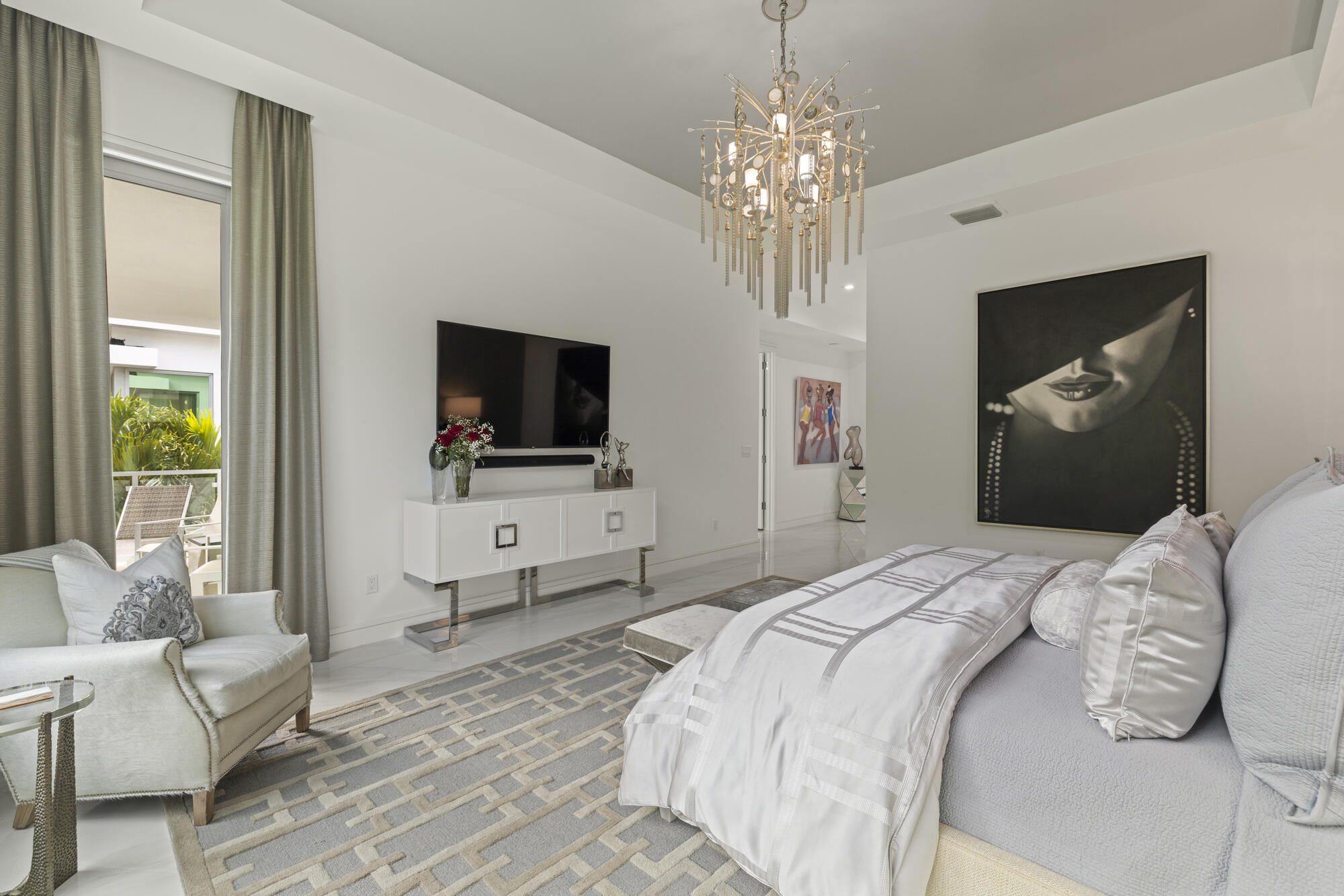 402 Ocean One Lane Juno Beach, FL 33408 - Photo 12 of 45 a bedroom with a bed and a flat screen tv