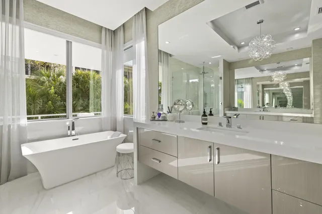 a spacious bathroom with a double vanity sink large mirror and a bathtub