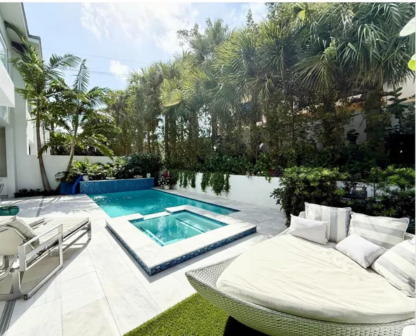 a view of a house with pool porch and sitting area