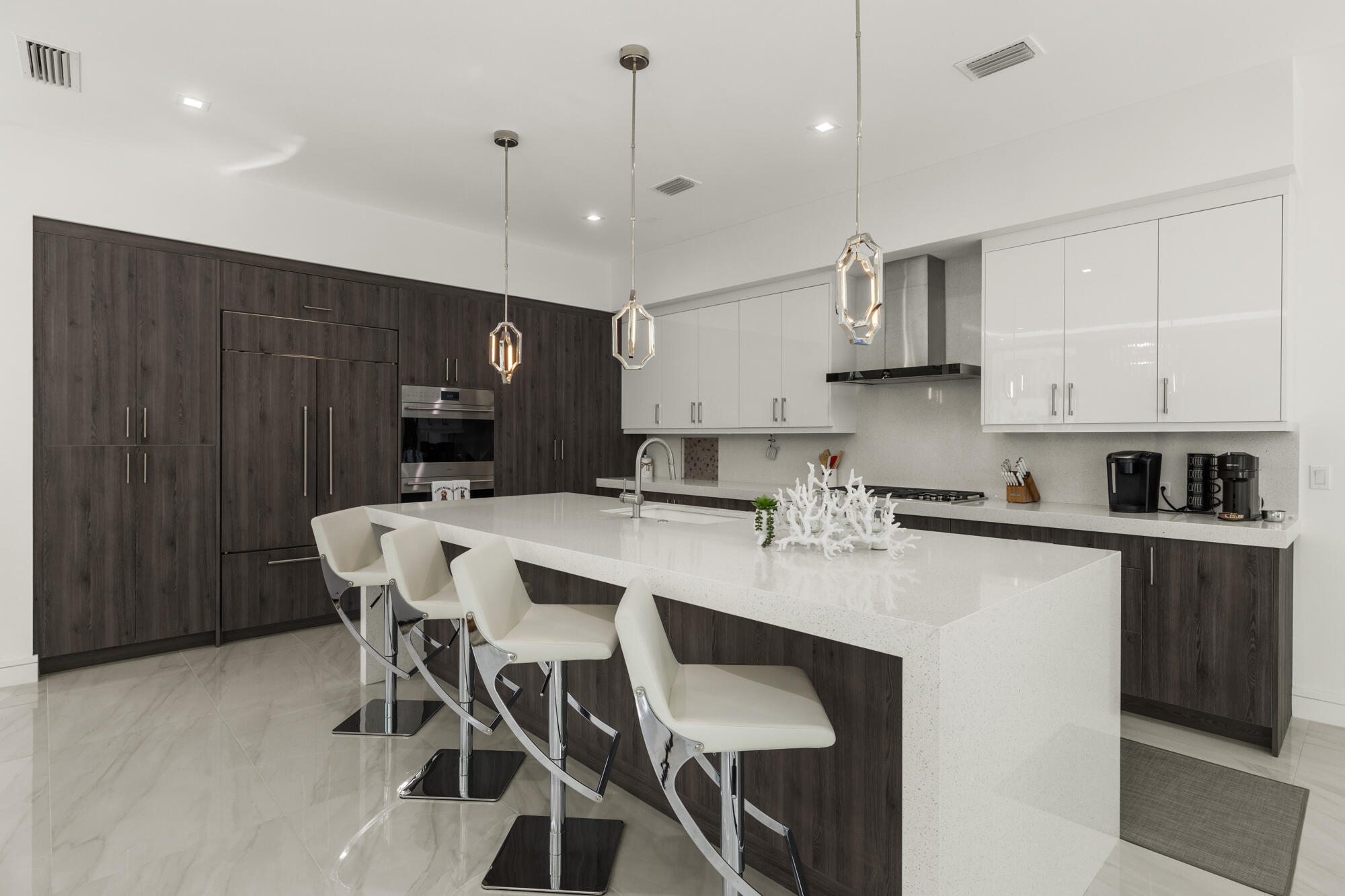 402 Ocean One Lane Juno Beach, FL 33408 - Photo 8 of 45 a kitchen with stainless steel appliances kitchen island granite countertop a dining table chairs sink and cabinets