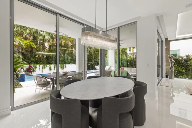 a view of a dining room with furniture large windows and wooden floor
