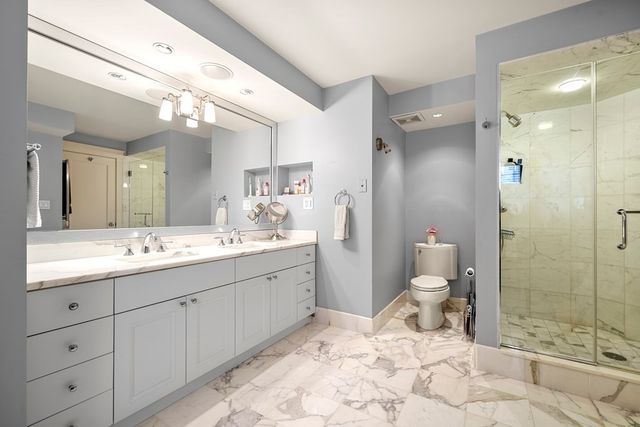 a bathroom with a sink toilet and shower