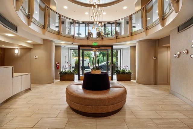 a living room with furniture and a chandelier