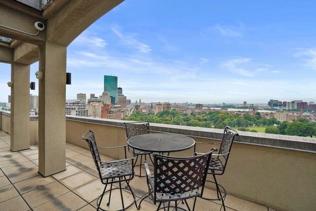 a view of a chairs and table in the balcony