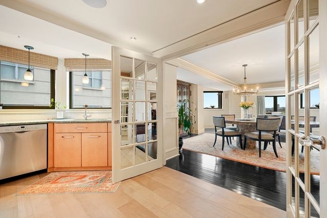 a view of a kitchen center island dining table and stainless steel appliances