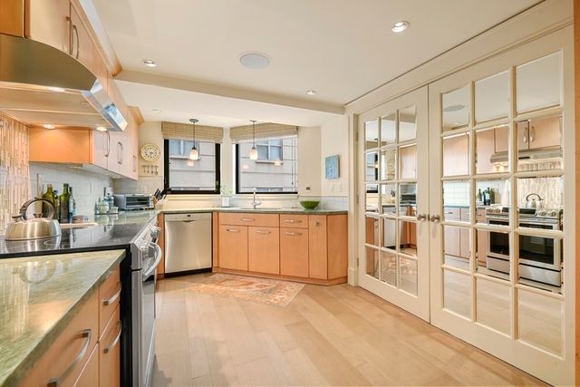 a kitchen with a sink stove and cabinets