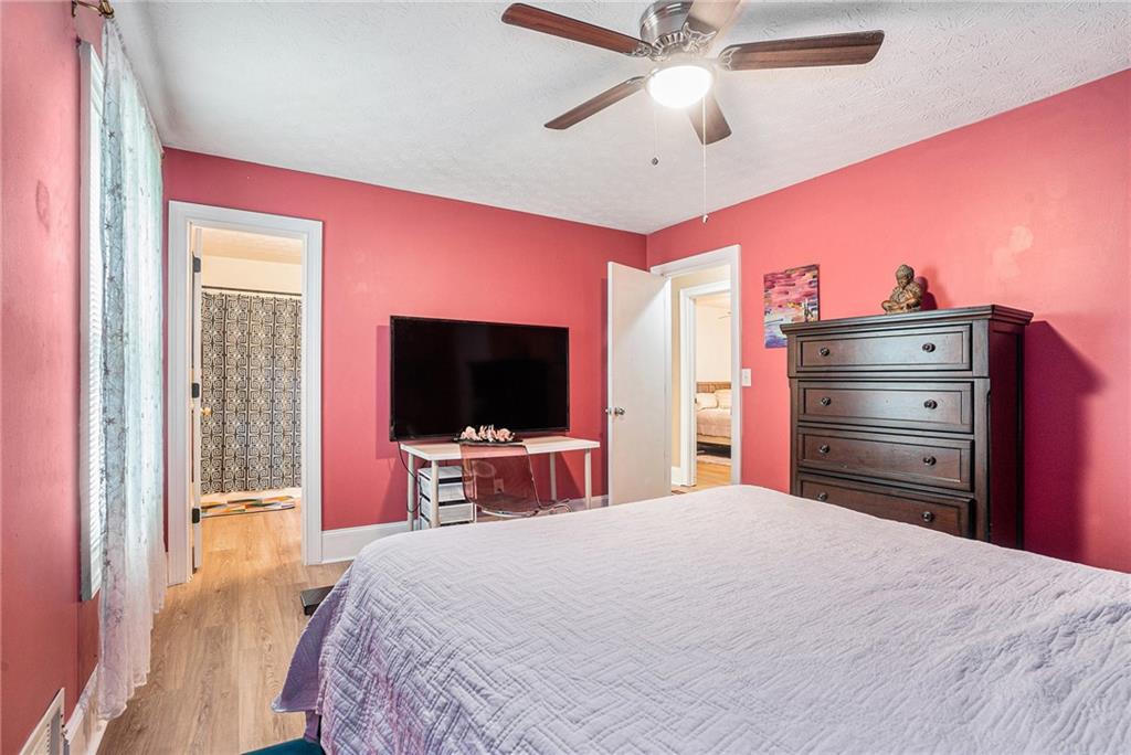 2247 Cruse Road Northwest Lawrenceville, GA 30044 - Photo 12 of 16 a bedroom with a bed and a flat screen tv
