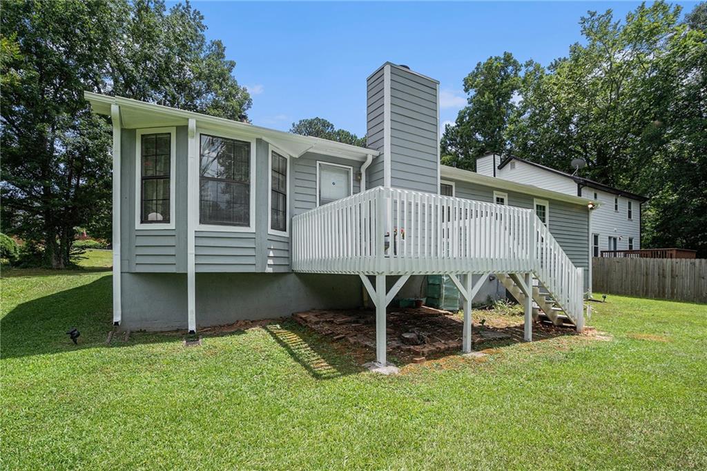 2247 Cruse Road Northwest Lawrenceville, GA 30044 - Photo 14 of 16 a view of a house with a yard and sitting area