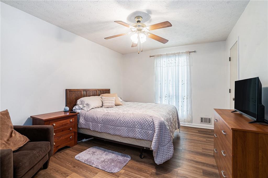 2247 Cruse Road Northwest Lawrenceville, GA 30044 - Photo 7 of 16 a bedroom with a bed and a flat screen tv