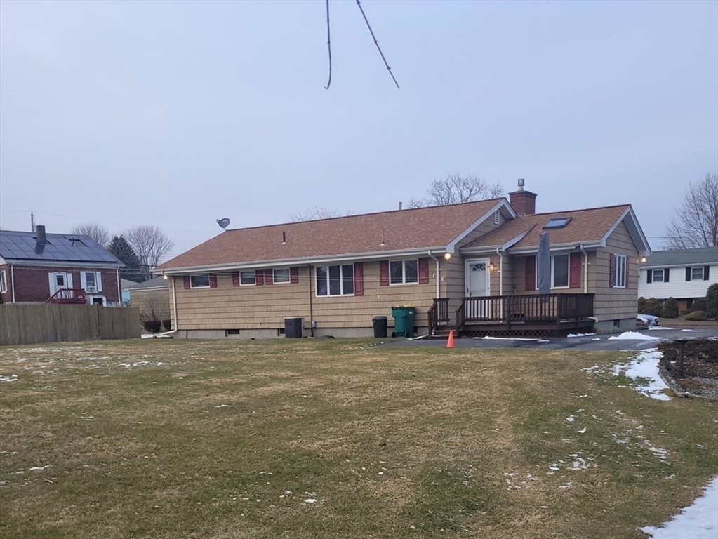 125 George Street Somerset, MA 02726 - Photo 2 of 9 a house that is sitting in the grass with large trees