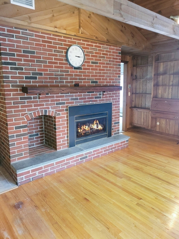 125 George Street Somerset, MA 02726 - Photo 3 of 9 a view of a fireplace with wooden floor