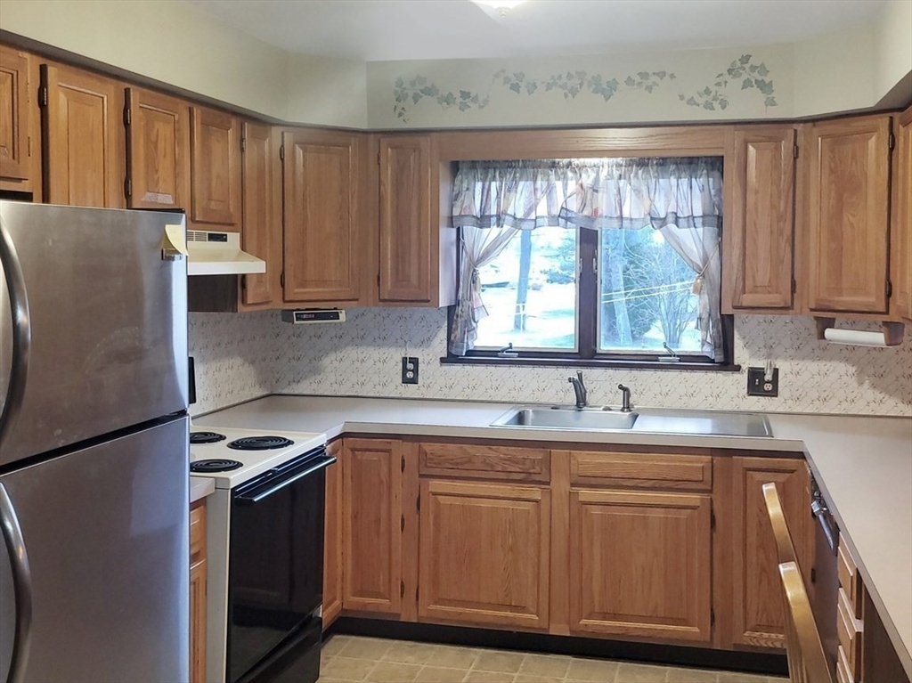 125 George Street Somerset, MA 02726 - Photo 6 of 9 a kitchen with a sink window and cabinets