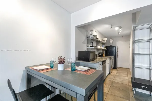 a kitchen with a table and chairs in it
