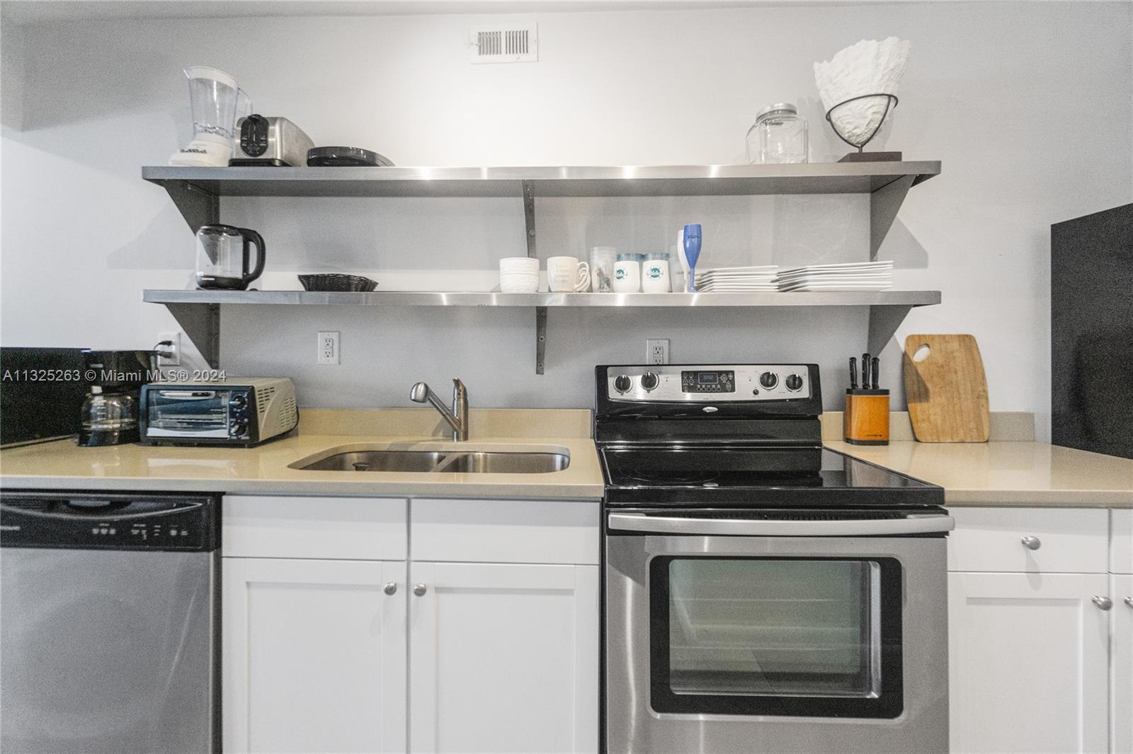 100 Lincoln Road, Unit 320 Miami Beach, FL 33139 - Photo 8 of 23 a kitchen with a stove and cabinets