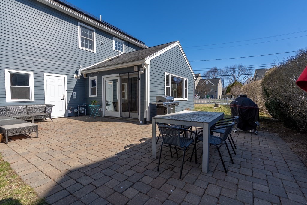 8 Hay Road Newton, MA 02459 - Photo 8 of 42 a patio with a table and chairs and potted plants